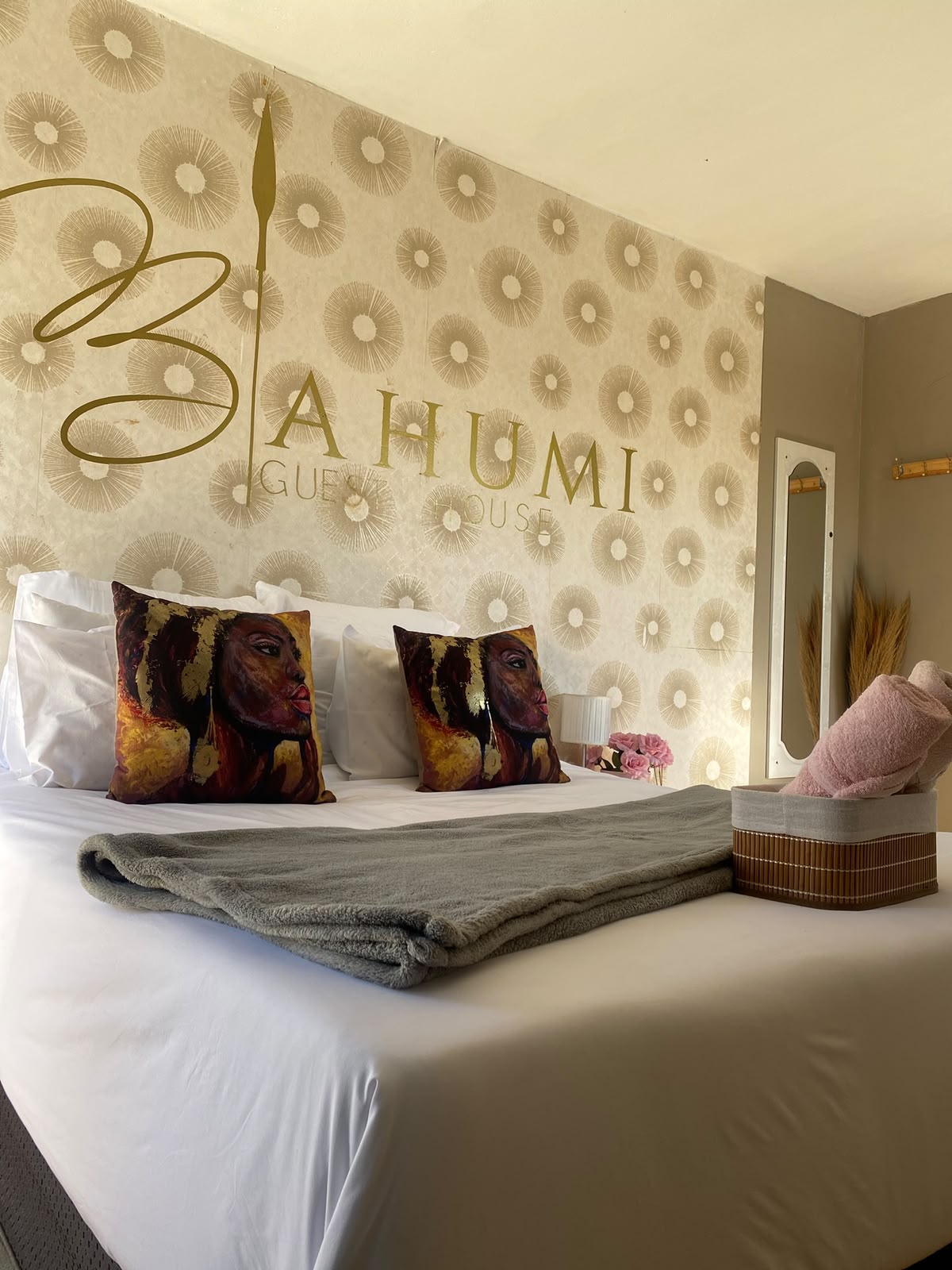 Bahumi Guest House signature feature wall with king bed and statement pillows