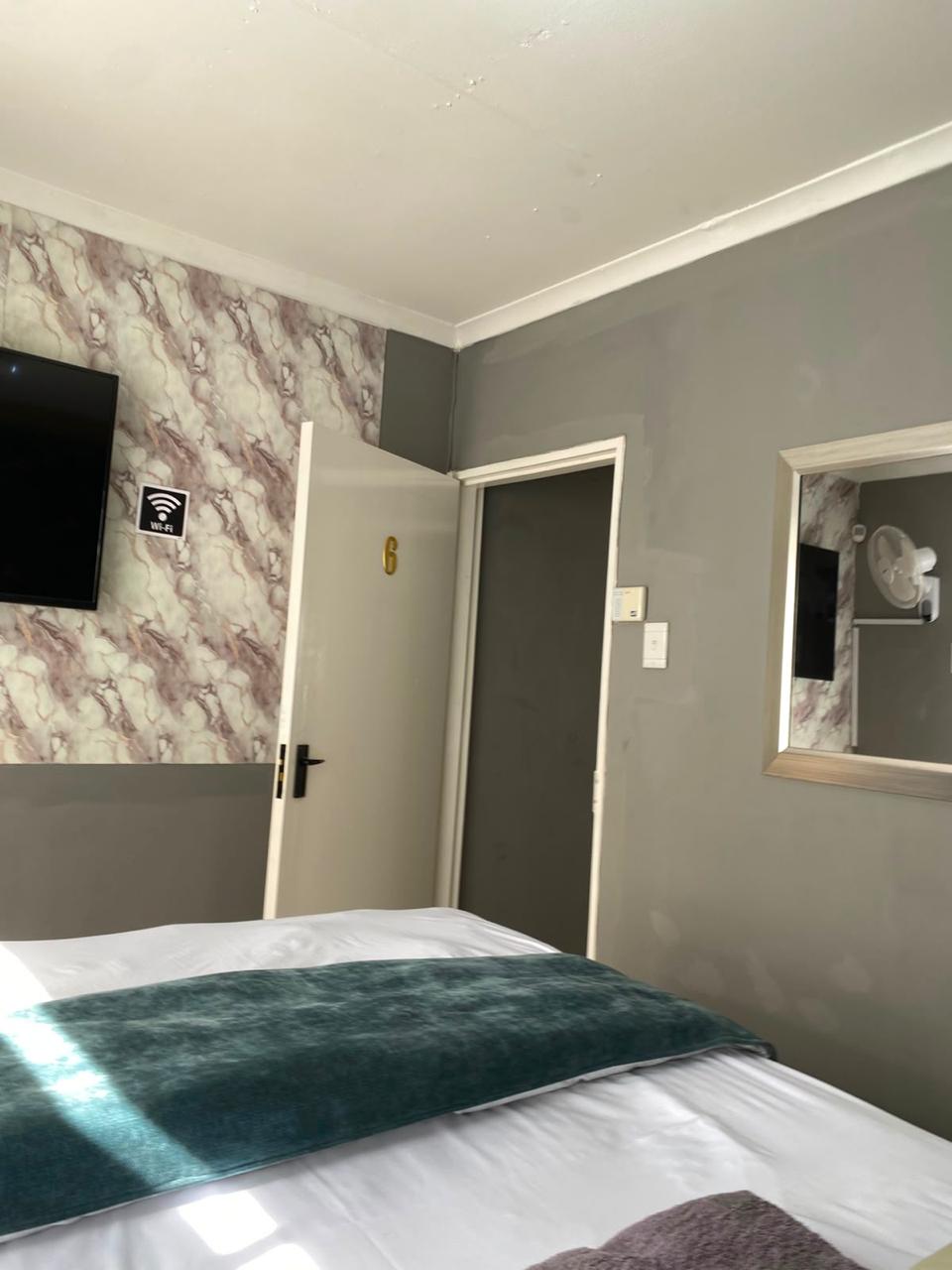Room 5 at Bahumi Guesthouse 2 with flat-screen TV, marble feature wall and Wi-Fi